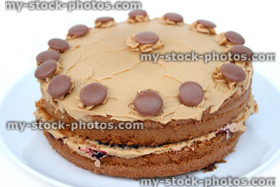 Stock image of homemade chocolate cake decorated with cream / chocolate buttons