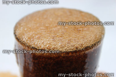 Stock image of fizzy cola being poured into glass, making bubbles