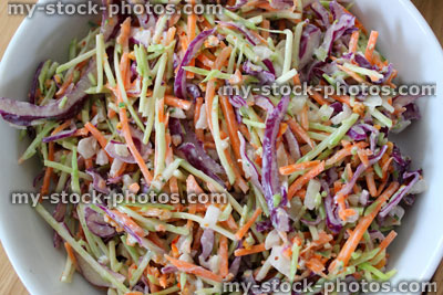 Stock image of homemade coleslaw, shredded red cabbage, grated carrot, sliced onion, mayonnaise