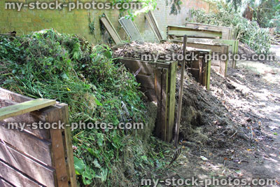 Stock image of wooden compost heaps, shady garden corner, recycling waste