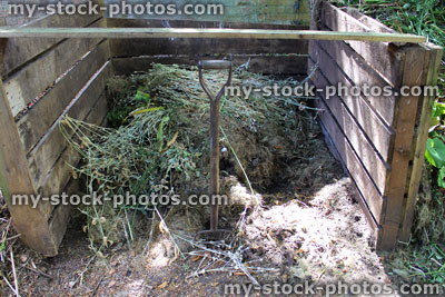 Stock image of wooden compost heaps, shady garden corner, recycling waste