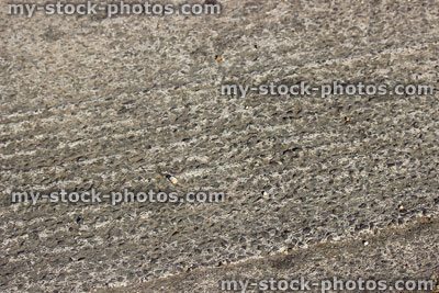 Stock image of concrete driveway ridges showing signs of erosion / wearing away
