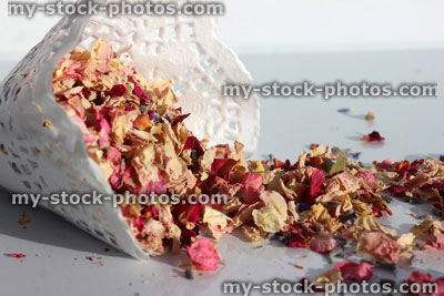 Stock image of natural biodegradable wedding confetti cone, dried delphinium / rose flower petals