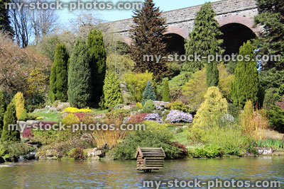 Stock image of pond with ripples and refections, by rock garden
