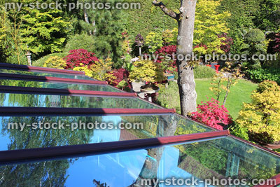Stock image of glass conservatory roof in back garden, leaning against house wall