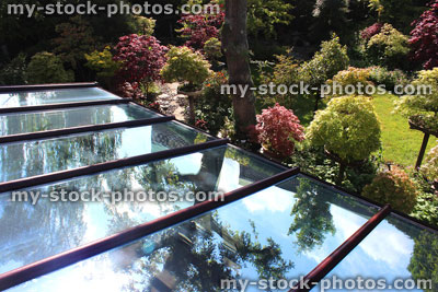 Stock image of glass conservatory roof panels / panes, reflecting blue sky