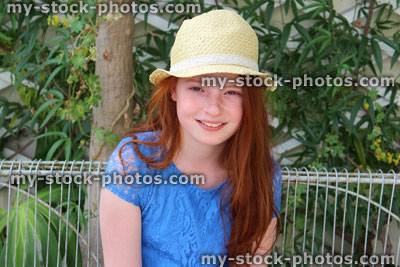 Stock image of girl sitting on white metal conservatory seat / bench, block paving, summerhouse