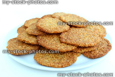 Stock image of freshly baked cookies / oat biscuits on white plate