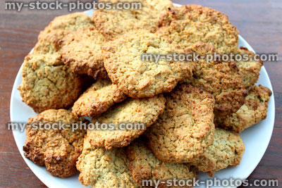 Stock image of freshly baked cookies / oat biscuits on white plate