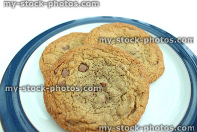 Stock image of large homemade chocolate chip cookies, on round plate