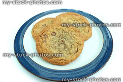 Stock image of large homemade chocolate chip cookies, on round plate
