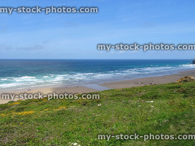 Stock image of Newquay's cornish coastline with rolling waves and surfers