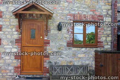 Stock image of wooden stable door on house, with porch roof
