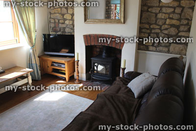 Stock image of traditional cottage sitting room / lounge, with leather sofa