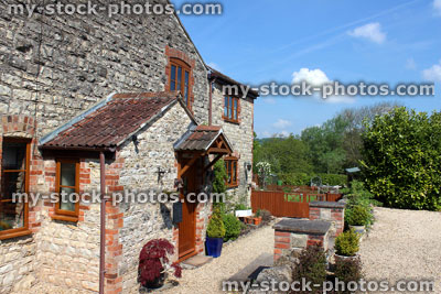 Stock image of traditional English cottage house / villa with stone walls and porch