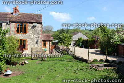 Stock image of cottage house in English countryside, with chickens / smallholding