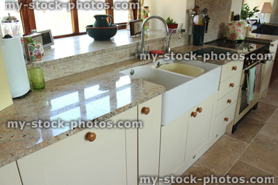 Stock image of cream Shaker kitchen, granite worktop surface, gas range cooker, Belfast sink