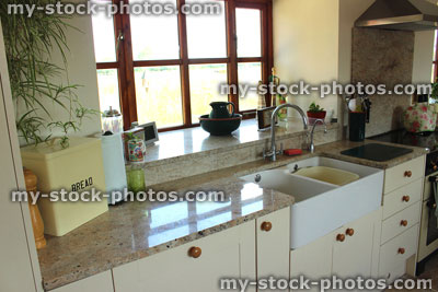 Stock image of country kitchen, granite worktops, Belfast sink, gas range cooker, Shaker cabinets