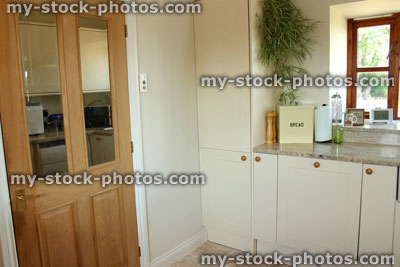 Stock image of country kitchen, Shaker cabinets, cream doors, pine door