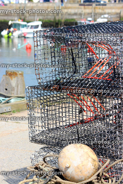 Stock image of empty crab and lobster pots by fishing harbourfront