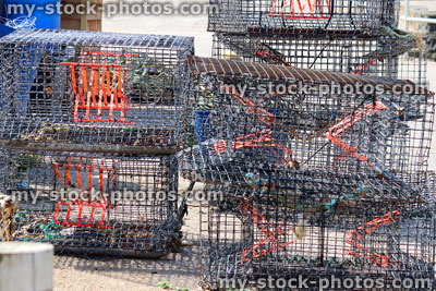 Stock image of empty crab / lobster pots at fishing harbour, black mesh