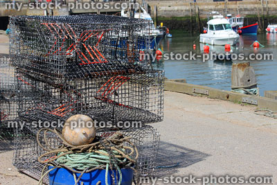 Stock image of buoys, boats and lobster pots in fishing harbour