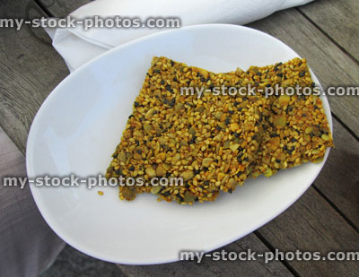 Stock image of gluten free seed crackers on a white plate