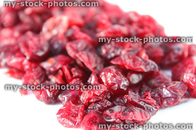 Stock image showing pile of dried cranberries / wrinkled red cranberry fruit healthy snacks
