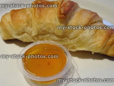 Stock image of freshly baked croissant / marmalade, being eaten for breakfast
