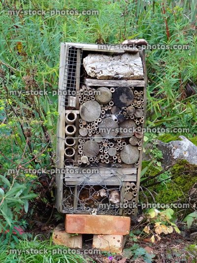 Stock image of tall, homemade insect house made from leftover wood