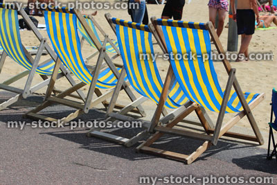 Stock image of striped deckchairs on beachfront promenade, traditional English beach