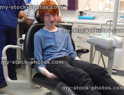 Stock image of worried boy in dentist chair, toothache, teeth, dental appointment