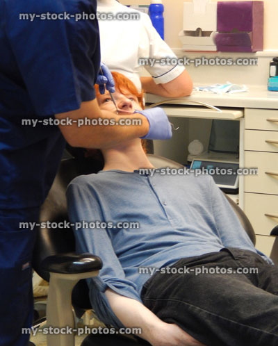Stock image of worried boy in dentist chair, toothache, teeth, dental appointment