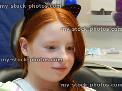 Stock image of worried girl in dentist chair, toothache, teeth, dental appointment