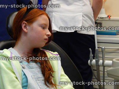 Stock image of worried girl in dentist chair, toothache, teeth, dental appointment