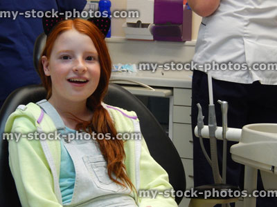Stock image of young girl in dentist chair, toothache, teeth, dental appointment