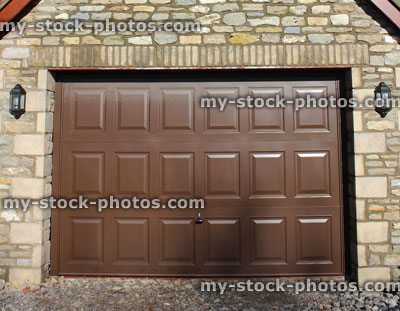 Stock image of detached garage, up and over garage door, outdoor security lights