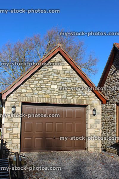 Stock image of detached garage, up and over garage door, bungalow back door, gravel driveway