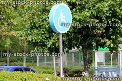 Stock image of round disabled parking sign / signpost, supermarket car park
