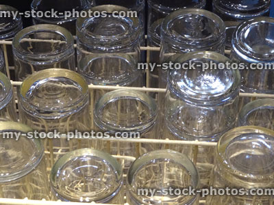 Stock image of upturned glasses drying in dishwasher