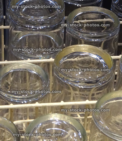 Stock image of upturned glasses drying in dishwasher after being washed