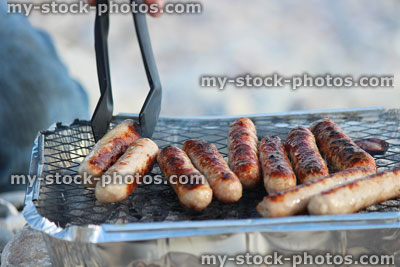 Stock image of disposable foil barbecue / beach bbq with lumpwood charcoal