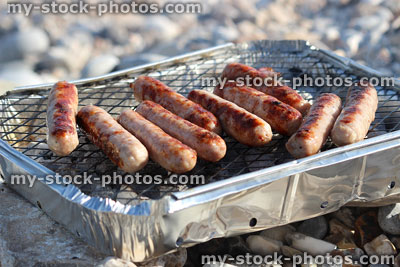 Stock image of party barbecue on beach, aluminium foil disposable bbq