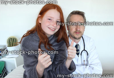 Stock image of sick girl with hospital doctor putting thumbs up