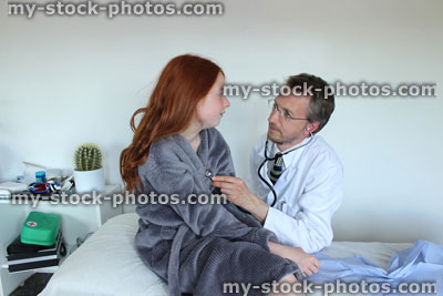Stock image of hospital doctor with stethoscope, listening to heartbeat of girl patient
