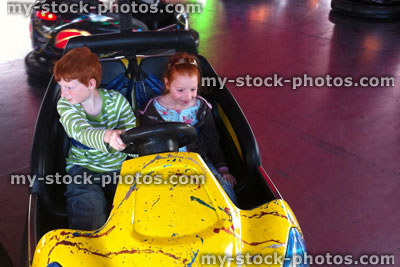 Stock image of children riding on fairground dodgems / bumper cars, funfair