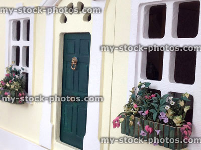 Stock image of dolls house front door and windowboxes