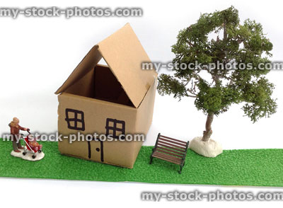 Stock image of cardboard dolls house with tree and figures 