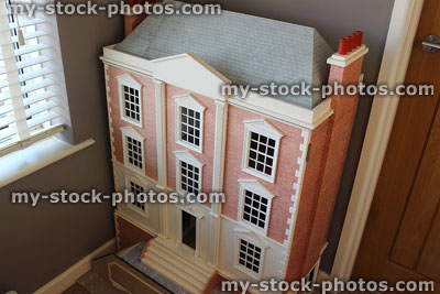 Stock image of homemade Georgian dollshouse with chimneys, slate roof, brick exterior