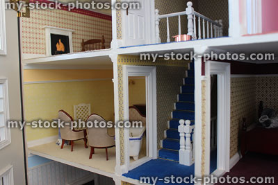 Stock image of toy dollshouse interior rooms, staircase, fireplace, carpets, furniture